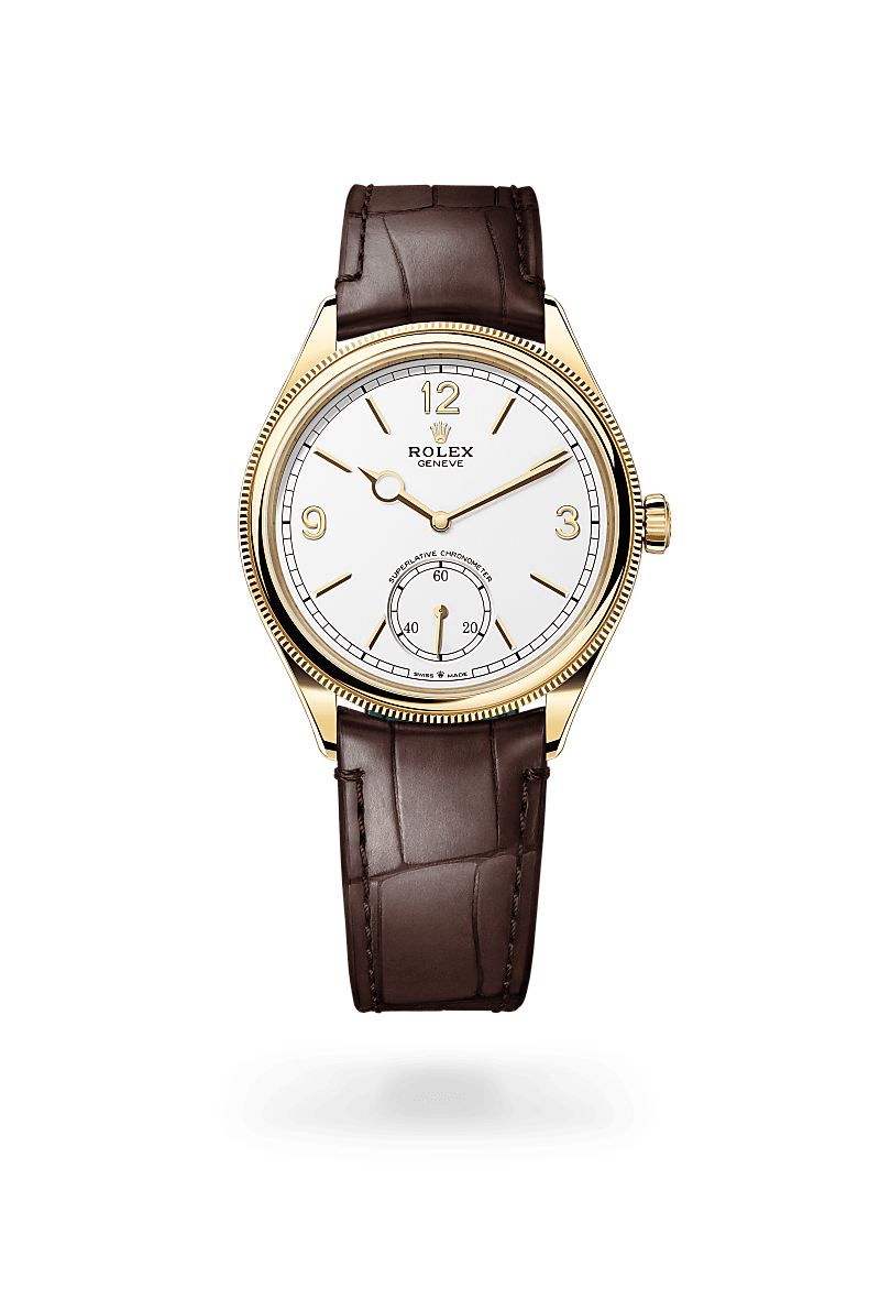 Rolex 1908 in 18 kt yellow gold with a intense white dial, domed and fluted bezel, and Leather strap bracelet.
